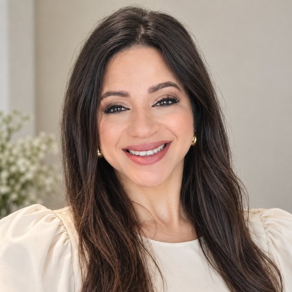 Anna Moraes, de blusa branca, sorrindo